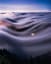 View of fog waves under the full moon at Mt Tamalpais State Park, CA