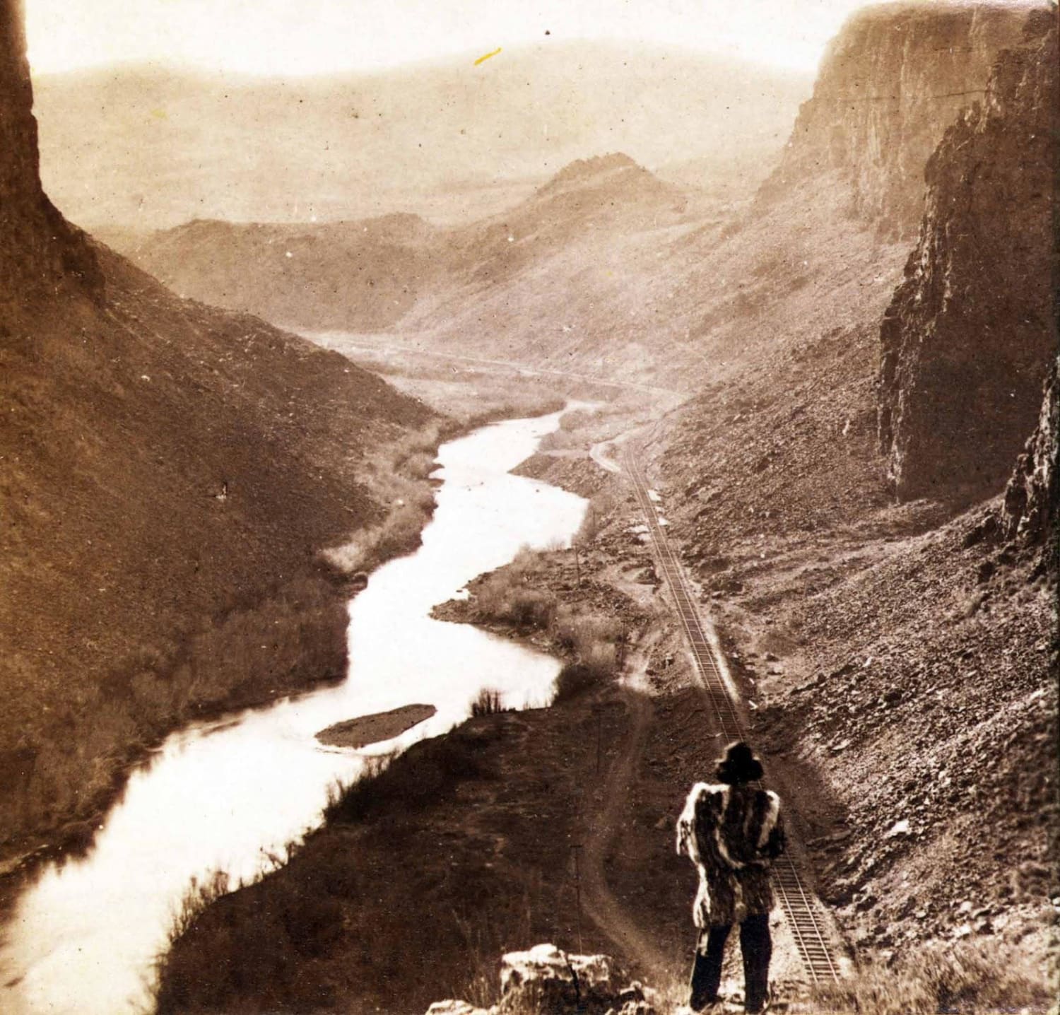 A Native American looks down upon a newly completed section of the Transcontinental Railroad, 435 miles from Sacramento, California - photo by Alfred A. Hart, 1867