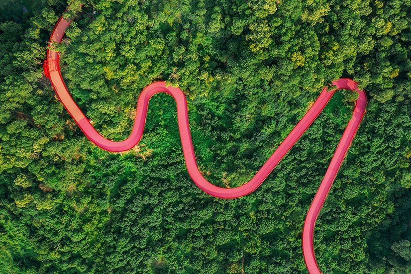 an elevated red path connects the 'forest and sports park' in shenzhen's guangming district