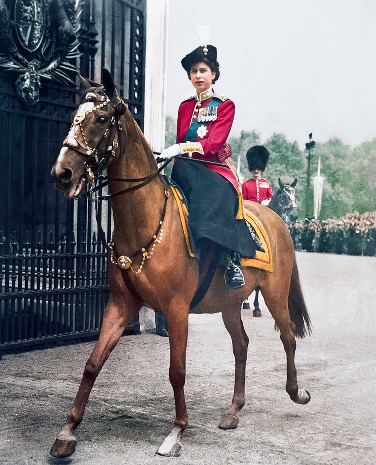Princess Elizabeth at the Trooping the Colour in 1951. She wears the scarlet tunic of the Grenadier Guards.