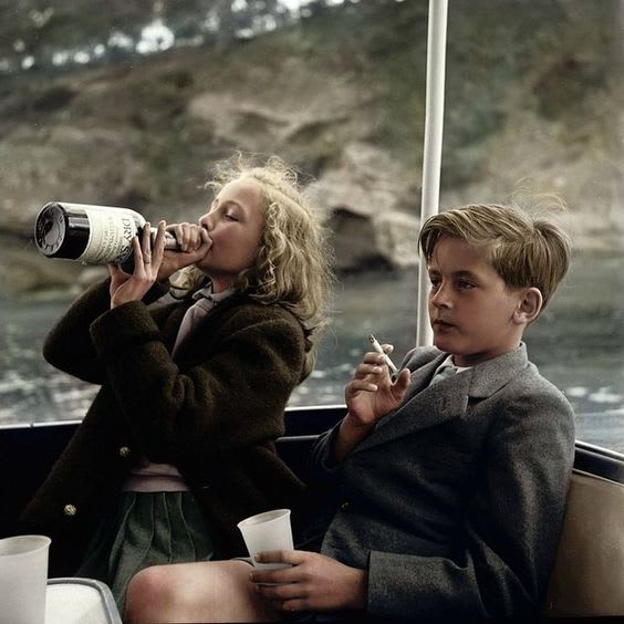 Princess Yvonne (13) and Prince Alexander (12) smoking and drinking on a yacht in Mallorca, 1955. [Colorized]