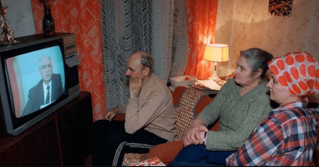 Soviet family watching the announcement of the USSR President Mikhail Gorbachev on his resignation. Photo by Sergei Karpukhin, December 25, 1991