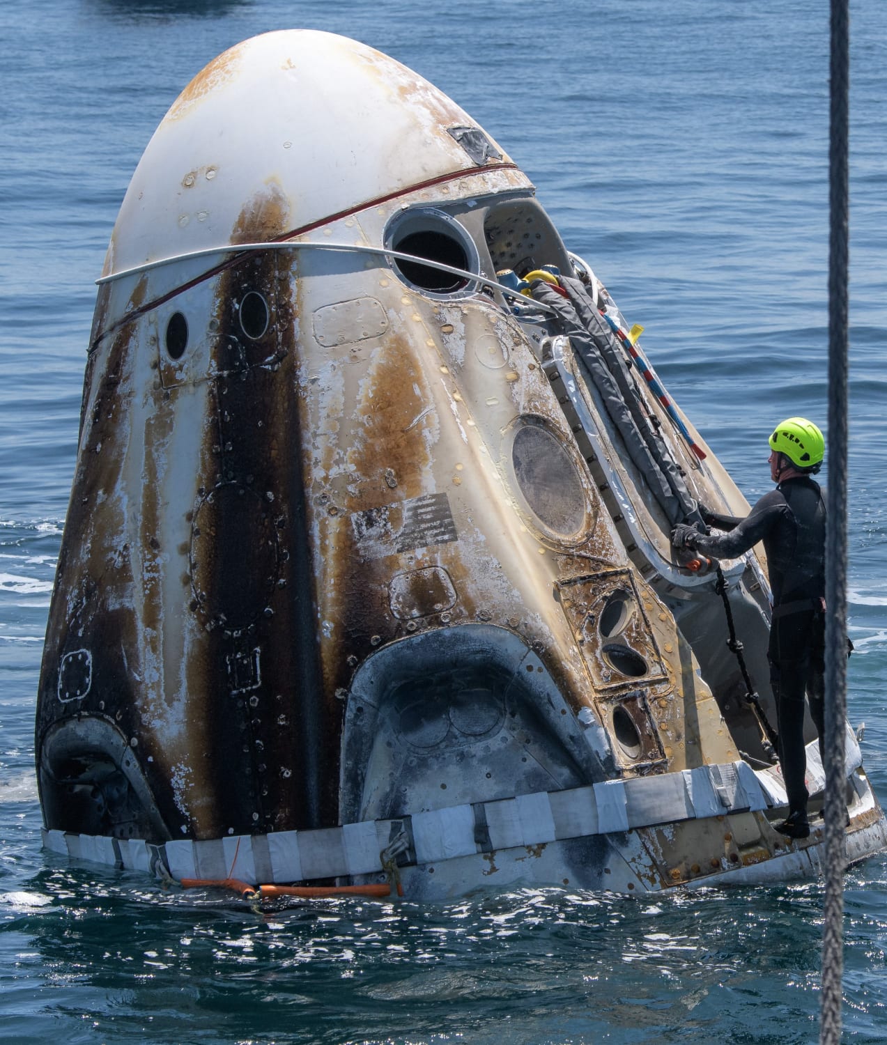 "Support teams arrive at the SpaceX Crew Dragon Endeavour spacecraft shortly after it landed with NASA astronauts Robert Behnken and Douglas Hurley onboard in the Gulf of Mexico off the coast of" Pensacola, Florida, United States of America, on 2 August 2020. Photographer: Bill Ingalls, NASA