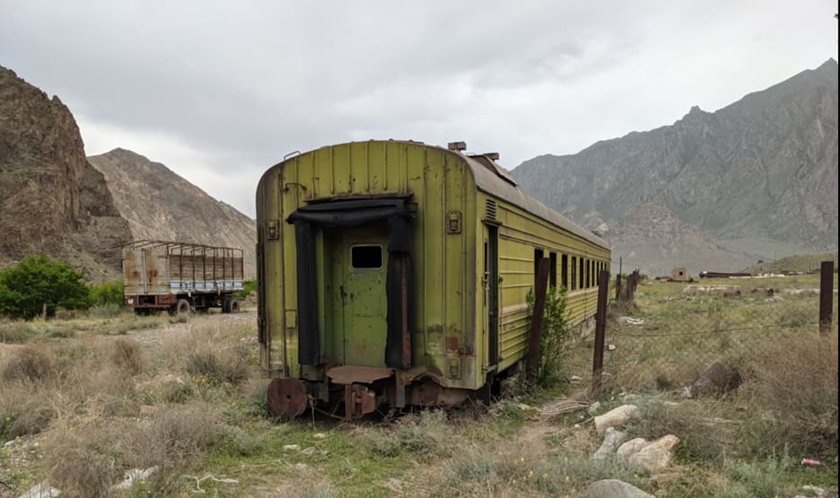 A rusted-out Trans-Caucasus Rail car sits vigil in southern Armenia, overlooking Iran. The old Soviet rail line was torn up decades ago.