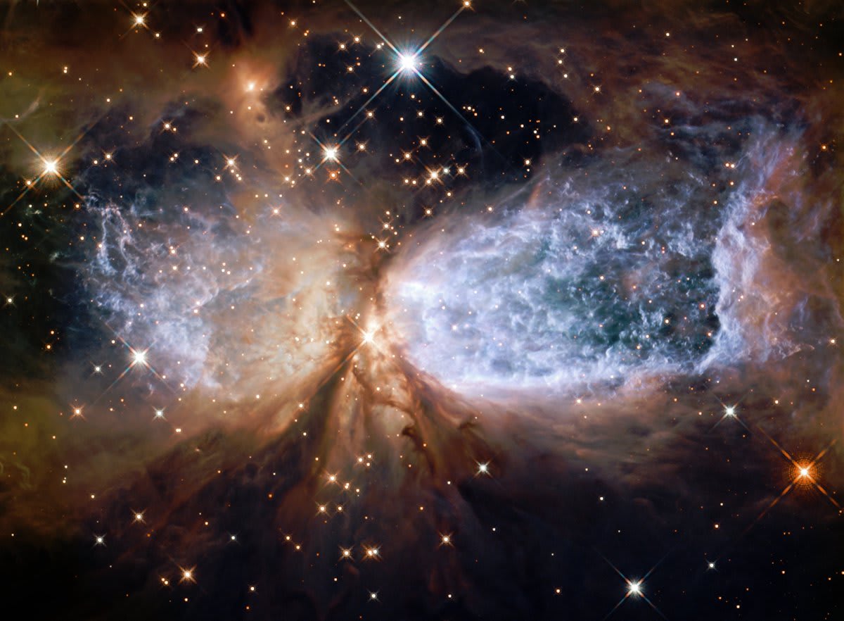 Day 3 of the 2020 Hubble Space Telescope Advent Calendar: A Shrouded Star. In the center of the image, a newly-formed star called S106 IR sits surrounded by gas and dust, in Sh 2-106, a compact star forming region about 2,000 light years away from Earth.