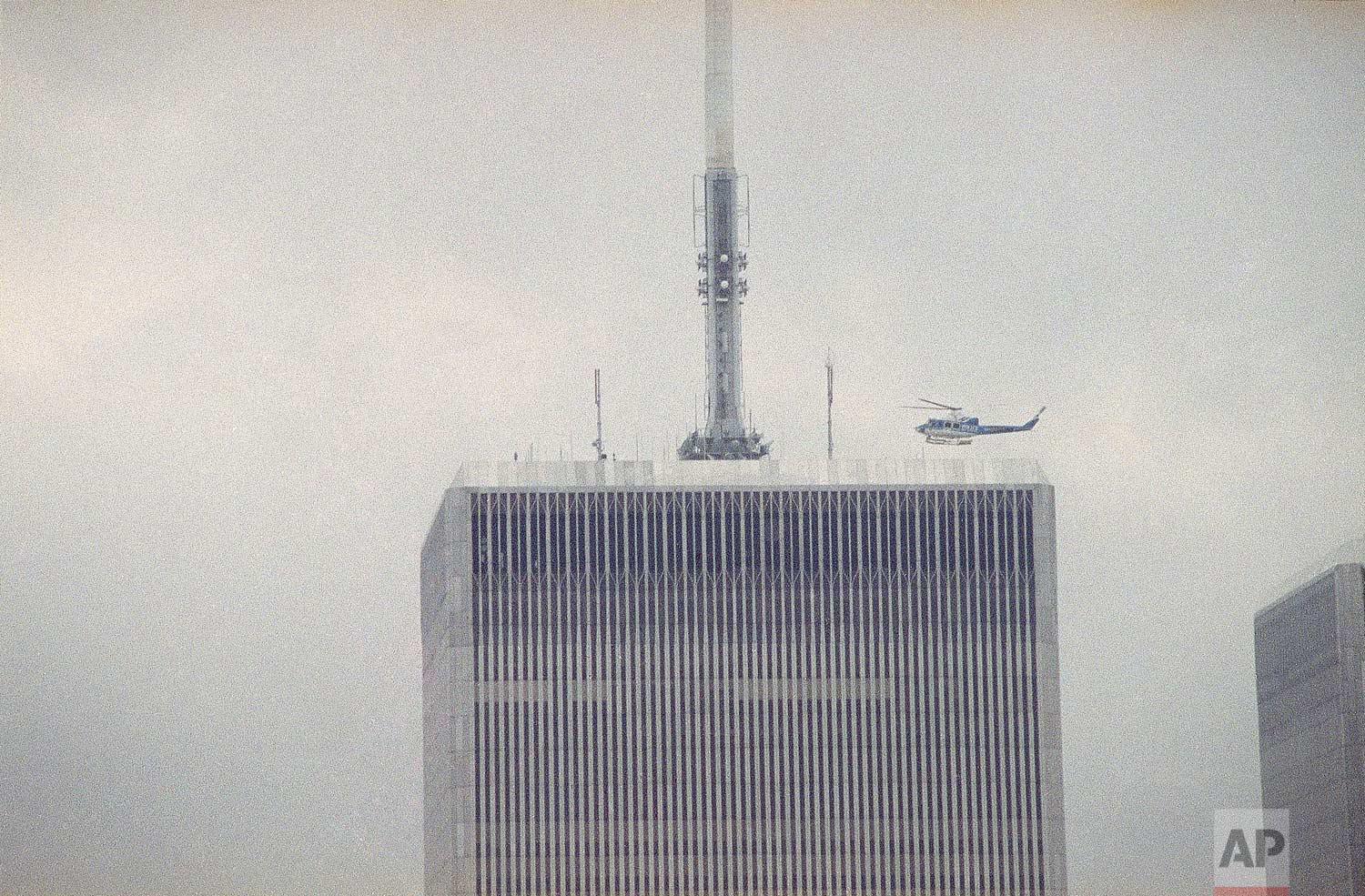 A NYPD helicopter readies to land atop the North Tower of the World Trade Center in New York to evacuate survivors stranded there, after a terrorist bomb explosion in an underground parking garage at the facility (February 26, 1993)