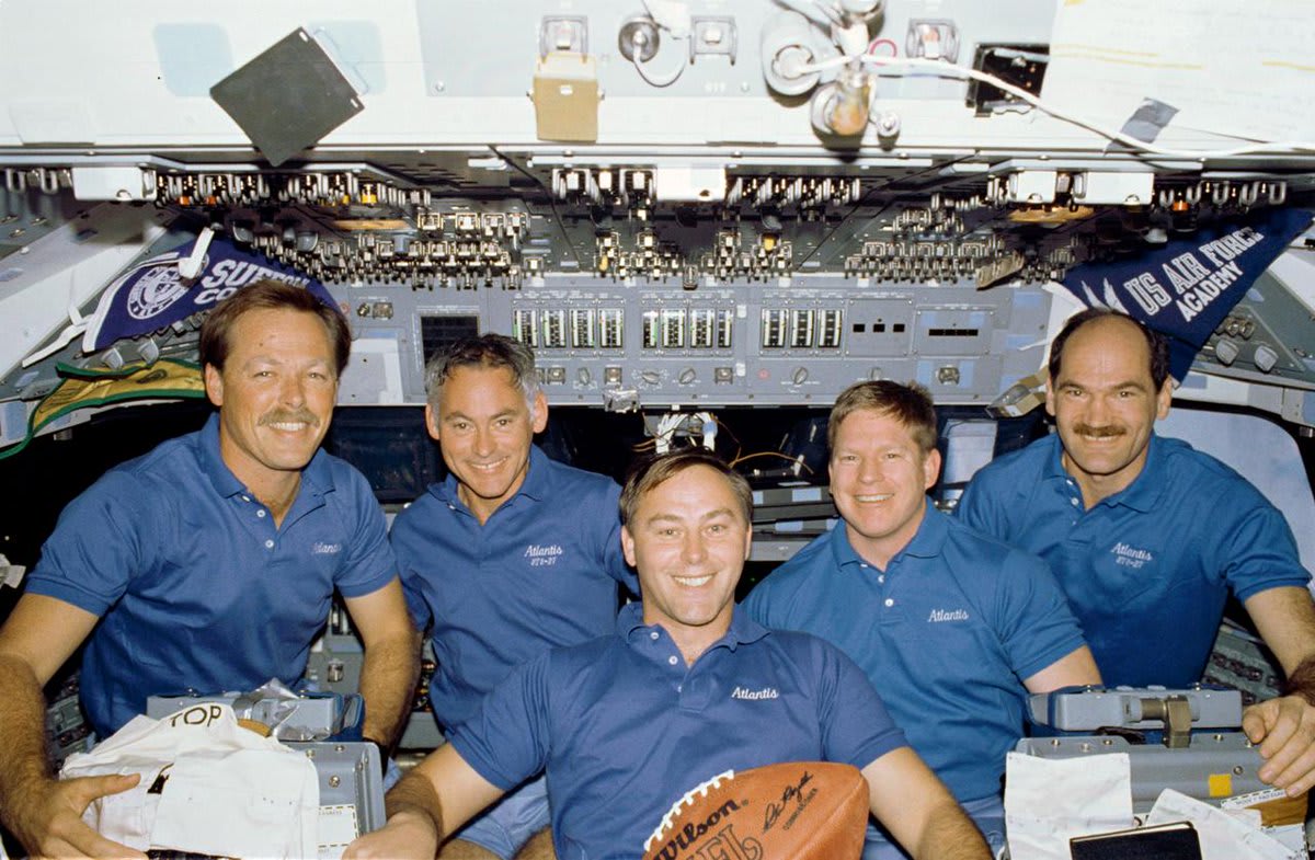Did you know that the crew of STS-27 brought a football up to space? Here they are striking a pose with the football on the flight deck of the Space Shuttle Atlantis. The football was later presented to the National Football League at halftime of the SuperBowl in Miami in 1989.