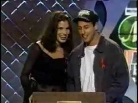 At the 1994 MTV Movie Awards, Sandra Bullock accidentally read Adam Sandler's cue card asking what it was like to kiss Keanu Reeves and he just ran with it