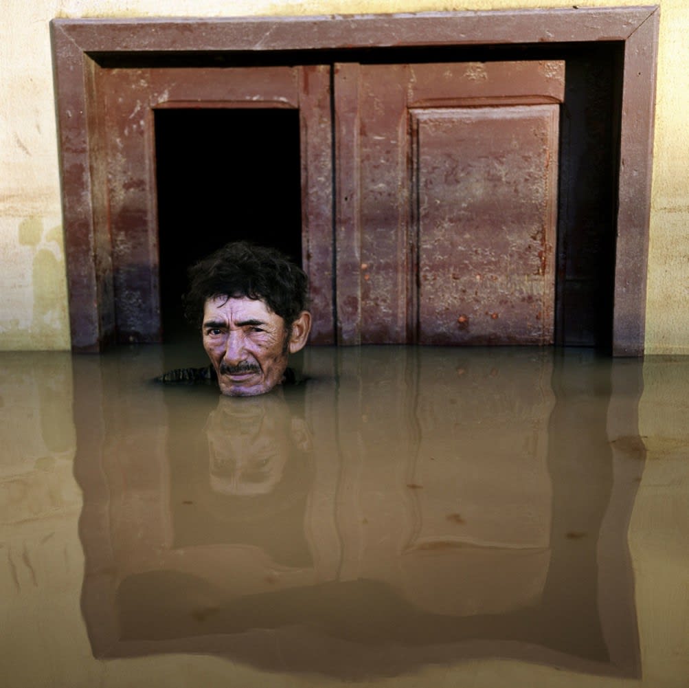 During the flood in March, 2015. Joao Pereira de Araujo of Taquari District, Rio Branco, Brazil. (Image - Gideon Mendel).