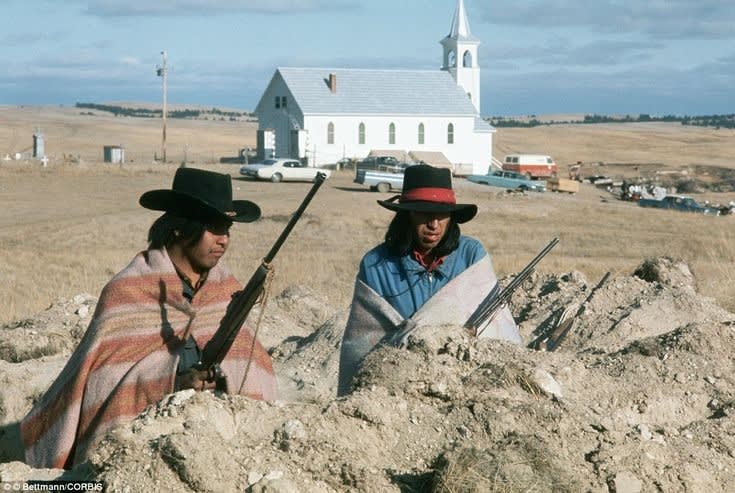 Two Members of AIM occupy a recently dug trench in Wounded knee South Dakota in the 71 day siege. 1973 [1001, 731]
