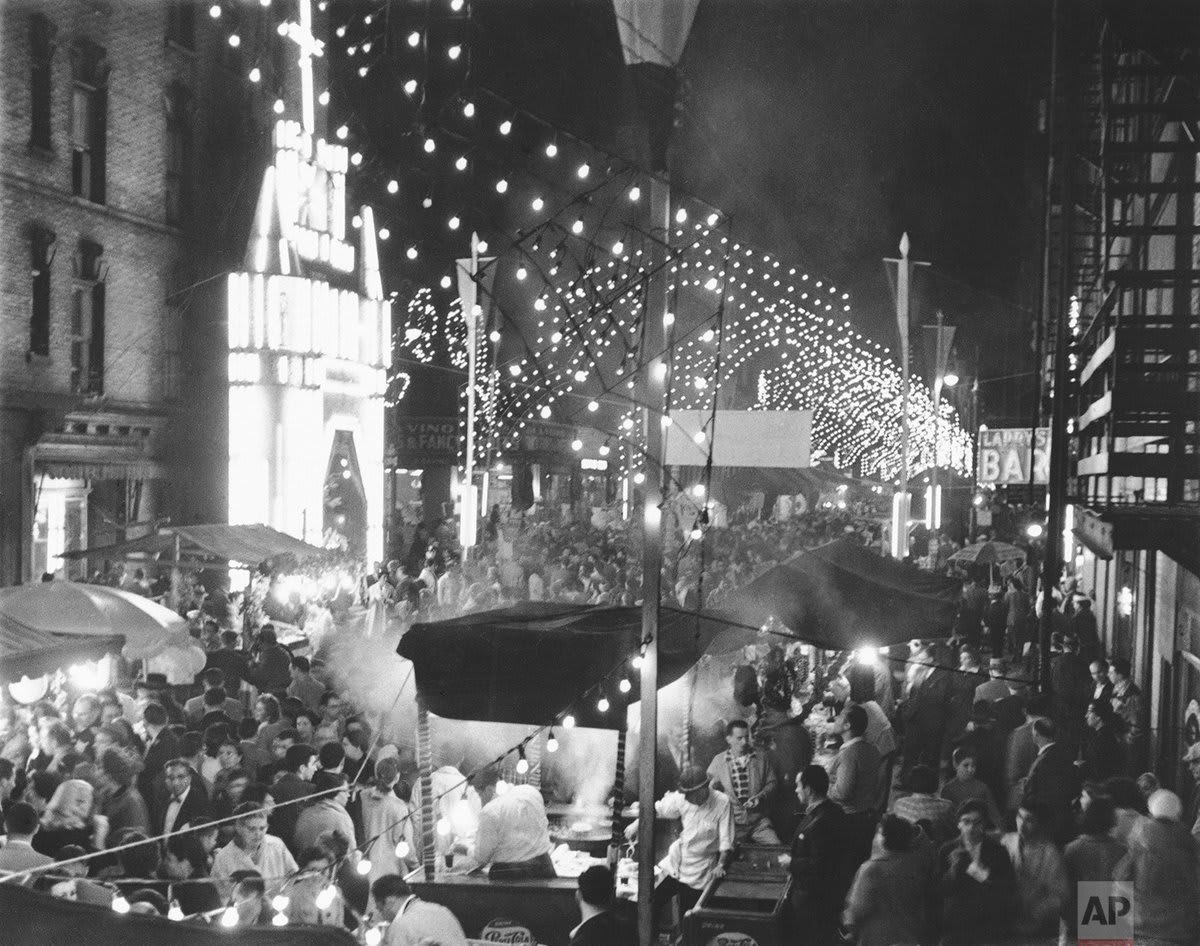 Residents of Little Italy celebrate the 30th annual San Gennaro festival in honor of Naples’ patron saint on the narrow streets of New York’s Lower East Side, Sept. 24, 1956.