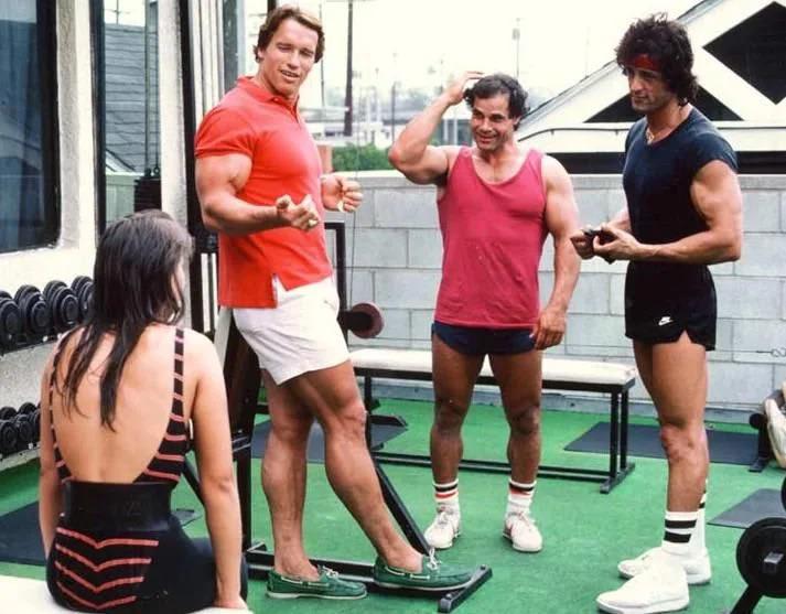 Schwarzenegger and Stallone working out together. Venice Beach, 1980s.
