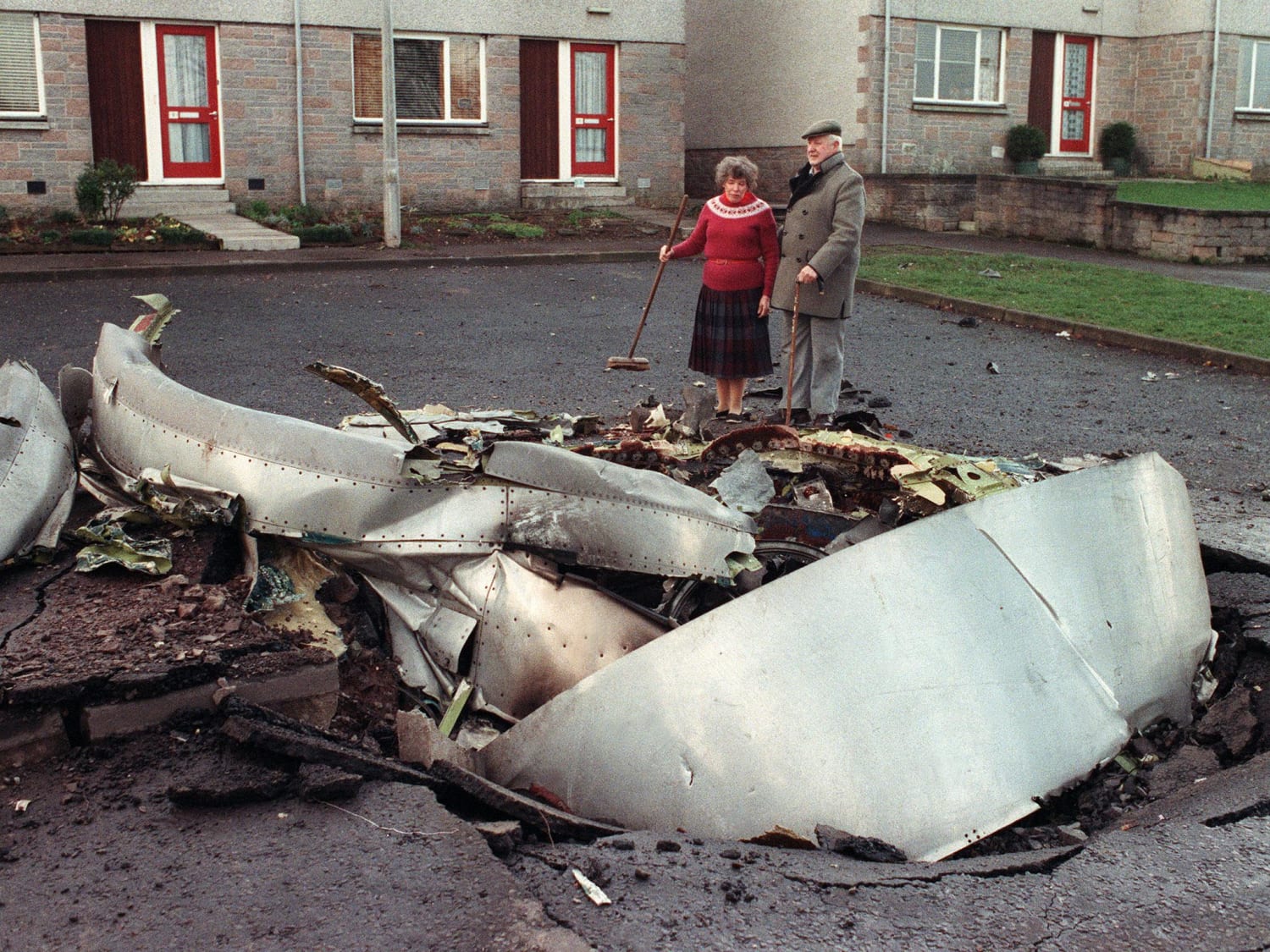 An elderly couple looks at some wreckage of "Clipper Maid of the Seas," the Pan Am 747-100 that came down on Lockerbie, Scotland after a bomb detonated killing all 259 onboard and 11 on the ground. Lockerbie Bombing December 1988