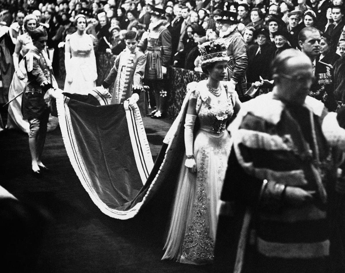 Queen Elizabeth II, wearing the imperial crown, walks through the Royal gallery to the House of Lords chamber to officiate at the opening of a new session of British Parliament in London in November, 1954 AP