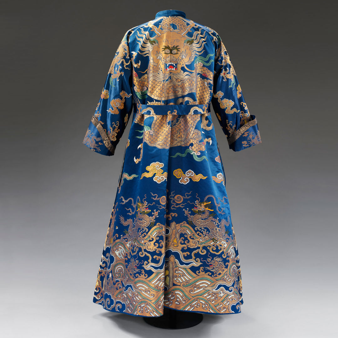 This is a banyan– an informal, loosely fitting men’s gown. Introduced to Europe from Asia during the 17thC, the cut was based on the Japanese kimono. This one was made from silk woven for a Chinese imperial court robe. Explore our China collection: