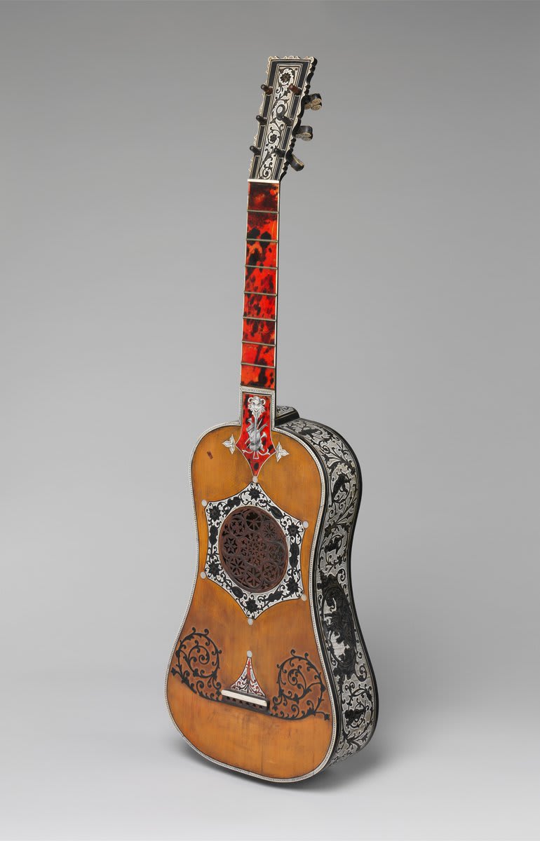 Rock out—it's NationalGuitarDay 🎸 This highly decorated instrument is an early example of a six-string, single-course guitar. The portrait on the guitar's back is believed to be the opera composer Giovanni Paisello, whose pieces were favored by 18th-century guitarists.