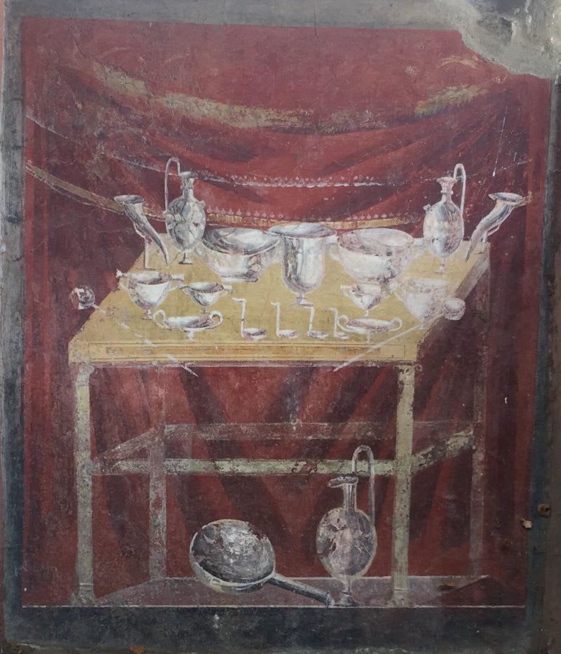 Roman fresco of a table bearing a rich display of silverware from Tomb of Caius Vestorius Priscus, one of the last to be built in Pompeii.