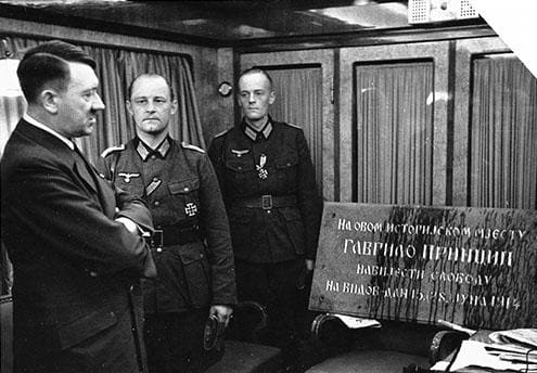 Hitler recieves a memorial plaque from Sarajevo which marked the place where Gavrilo Princip shot dead the Archduke Franz Ferdinand. It was a present for his 52nd birthday. The photo was taken during the ongoing offensive on Yugoslavia, 20th April 1941 in Graz, Austria.