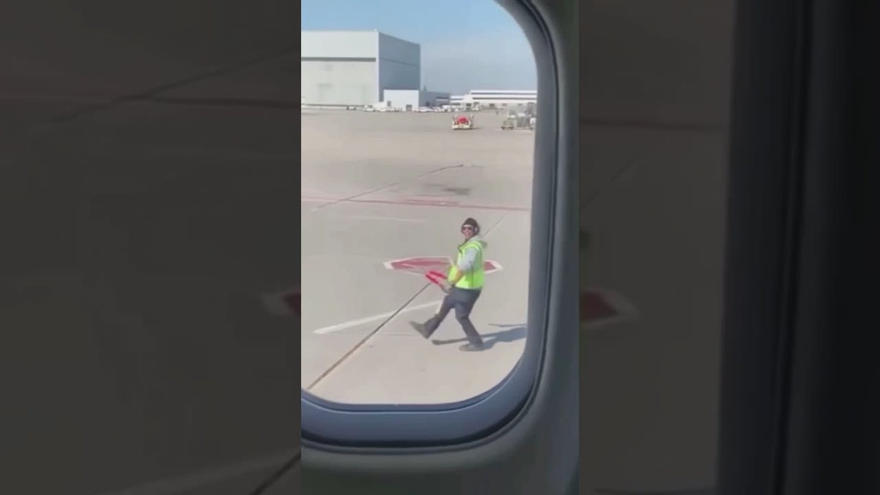 An Airport Baggage Handler Having A Good Day