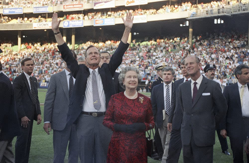 George H.W. Bush, a life-long baseball fan, takes Queen Elizabeth and Prince Phillip to a Baltimore Orioles vs. Oakland Athletics game in 1991- the first time the Queen had been to a baseball game.