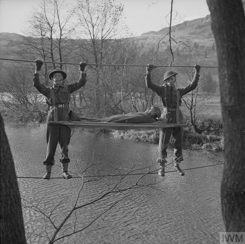 That’s one way of carrying a stretcher! Members of 298 Field Ambulance Company, Royal Army Medical Corps carrying a stretcher across a river at Grasmere in the Lake District, OnThisDay in 1943. © IWM H 34480