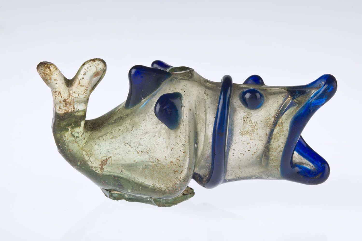 An Umayyad glass flask in the shape of a fish, used as a container for perfume, balsam or kohl. Made in Egypt or Syria, 7th-8th century CE, now on display at the Museum of Islamic Art in Doha, Qatar