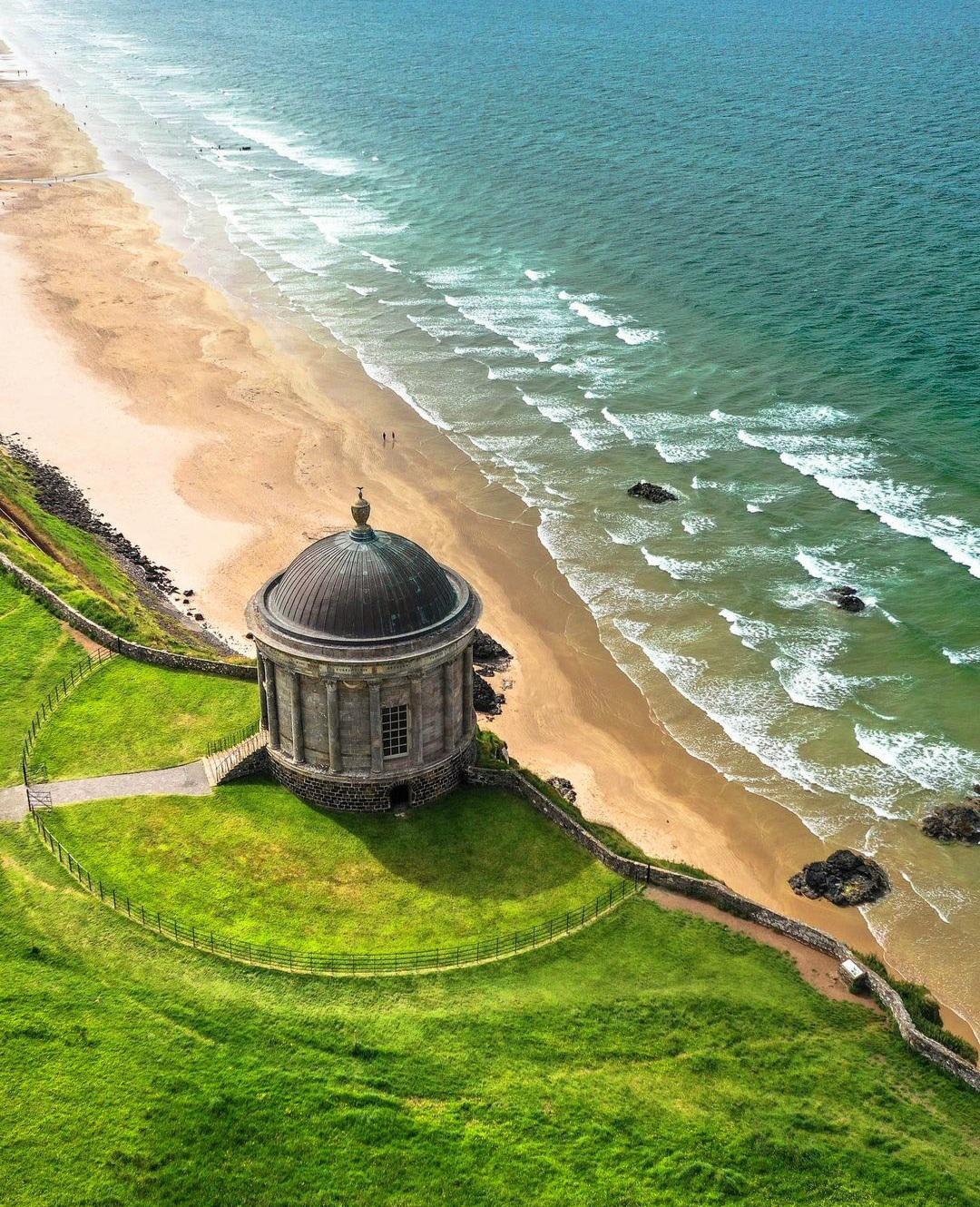 The 18th century Musseden Temple perched the vertical cliffs of Downhill Beach, near Castlerock, County Antrim, Ireland.