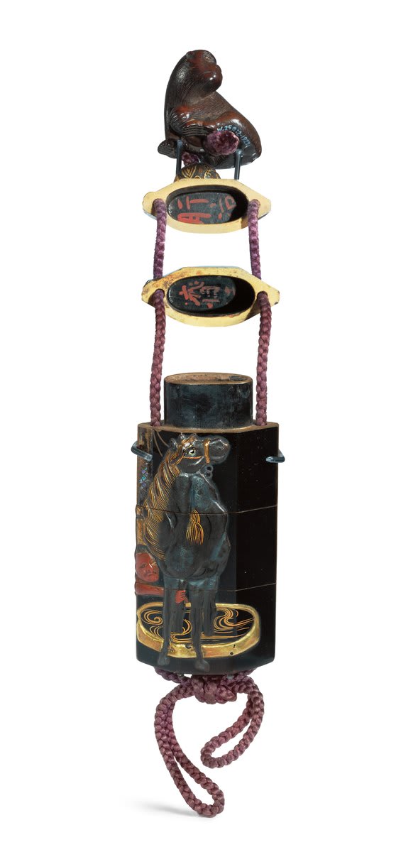 Made up of several tiers, Inro were traditionally worn as part of the kimono, suspended by a silk cord and a netsuke, (toggle). This Inro depicts a groom washing his horse, whilst the wood netsuke is carved in the shape of a monkey. Book
