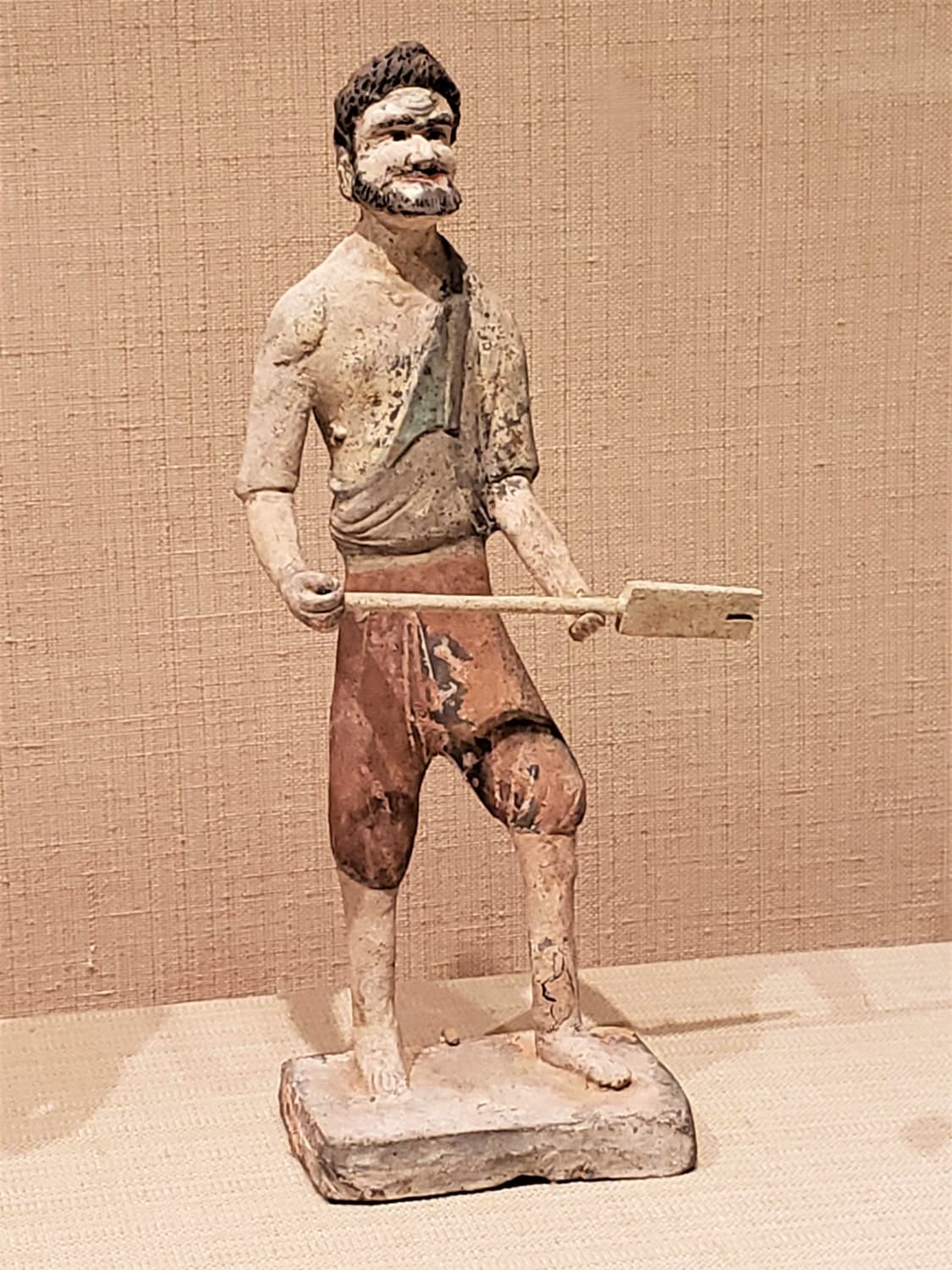Earthenware statuette of man with shovel. Tang dynasty Chinese, 7th c.