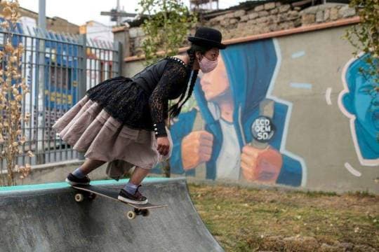 A woman wearing the traditional clothes of a "cholita" participates in a skate festival in La Paz, Bolivia