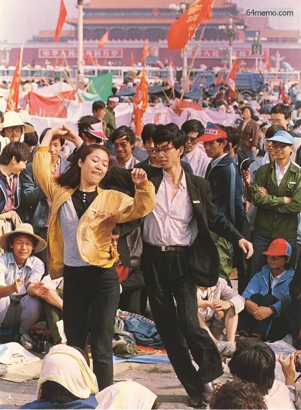 Two young people dancing in a crowd of demonstrators in Tiananmen Square, Beijing, May 1989.