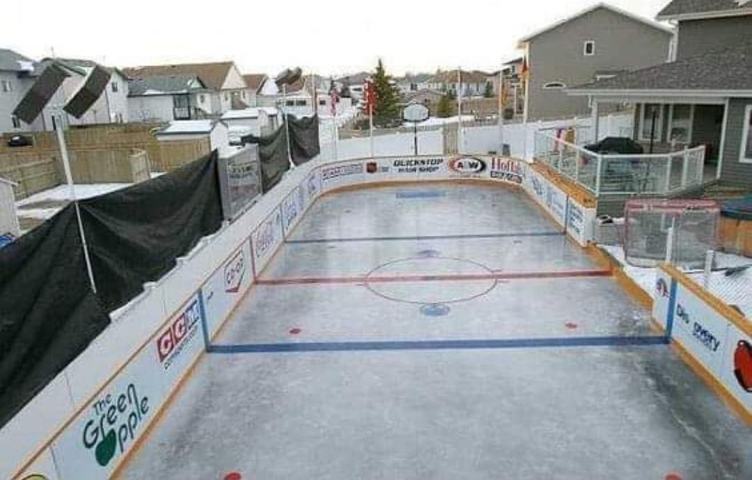 Two houses in Red Deer Alberta Join backyards every winter to make a hockey rink for kids.