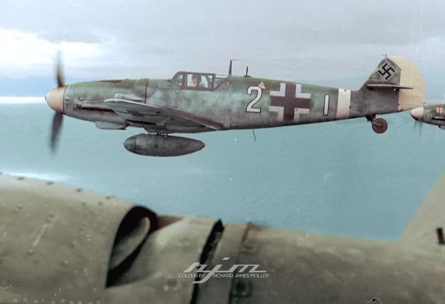 Bf 109 G-6/Trop W.Nr. 14. "Weisse 2", of Lt. Josef Emil Clade, 7./JG 27, whilst escorting the He 111 H transporting the Generals Fiebig and Holle to Crete, December 1943. In the background is the nose of Bf 109 G-6 W.Nr. unknown "Weisse 9", of Uffz Moycis, 7./JG 27