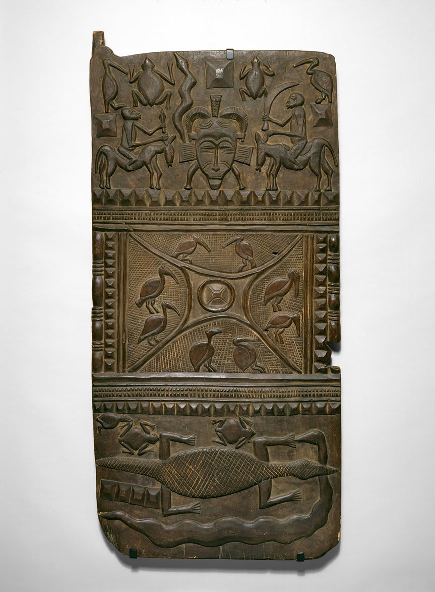 Artist Nyaamadyo Koné worked in the vicinity of the influential regional woodcarving center of Kolia in Côte d’Ivoire. He was among the very few Senufo artists of the 20th century to achieve fame for making doors with bas-relief decorations of this size and complexity.