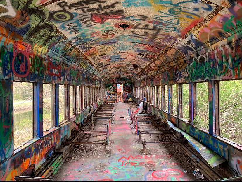 Abandoned train car in the woods decorated with graffiti. Lambertville NJ. Picture taken spring 2021.
