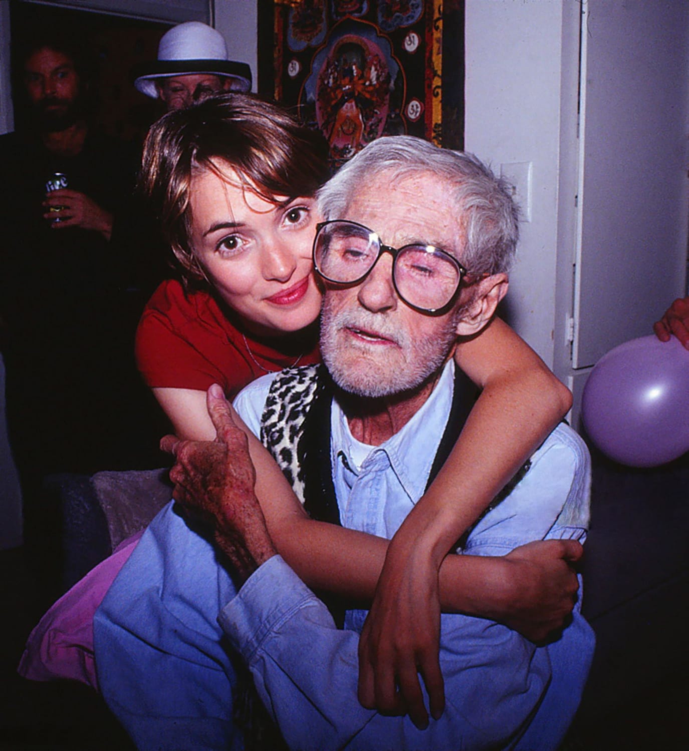 Winona Ryder embraces her godfather Timothy Leary at his home on Good Friday in Beverly Hills, 1996