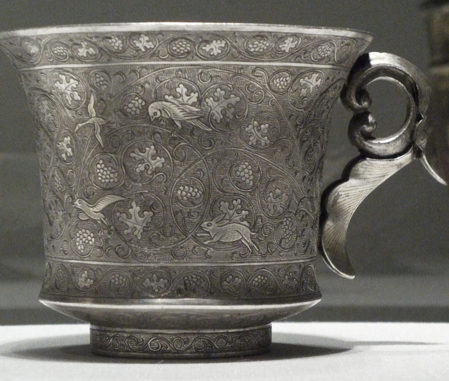 Silver wine cup, with birds and a rabbit amid scrolling plant forms. From China, Tang Dynasty, 8th century CE, now housed at the Freer Gallery of Art in Washington, D.C.