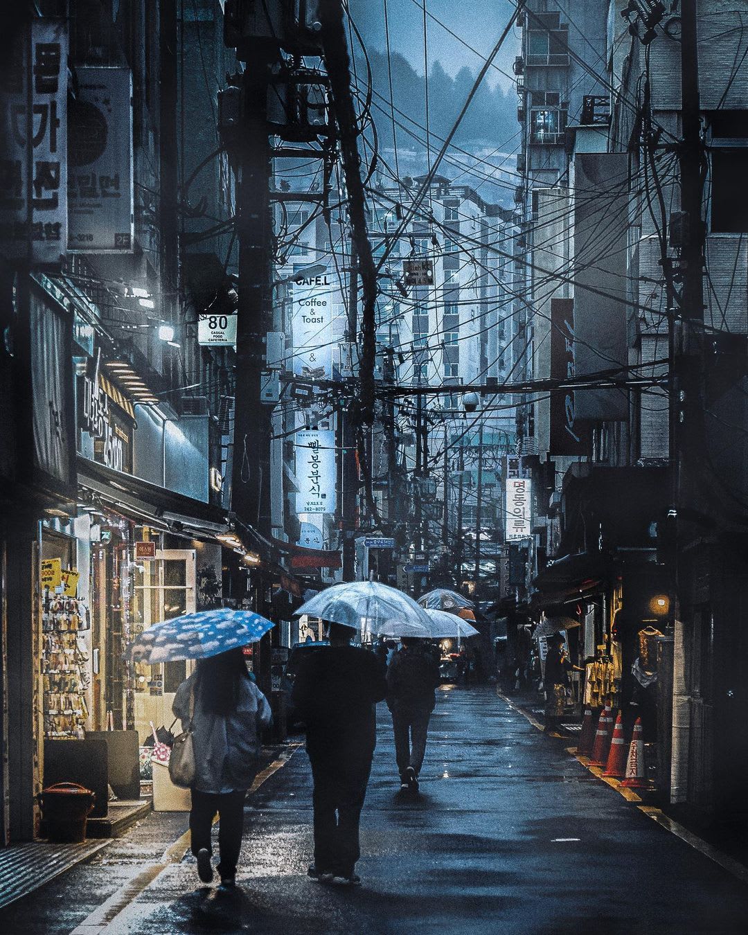 Rain drenched street with messy overhead cables, Busan, South Korea.