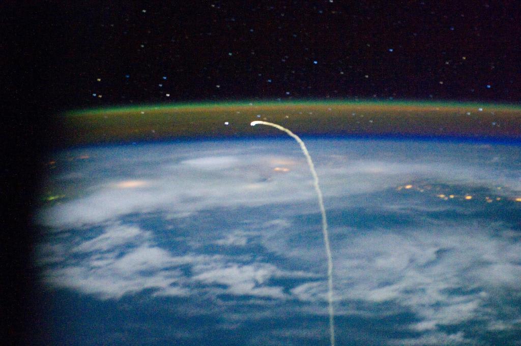 STS-135 returned to Earth OTD in 2011, it was the final mission of Space Shuttle Program. In this image from the Expedition 28 crew on the ISS, Atlantis appears “like a bean sprout against clouds and city lights” on its way home. Airglow over Earth can be seen in the background.