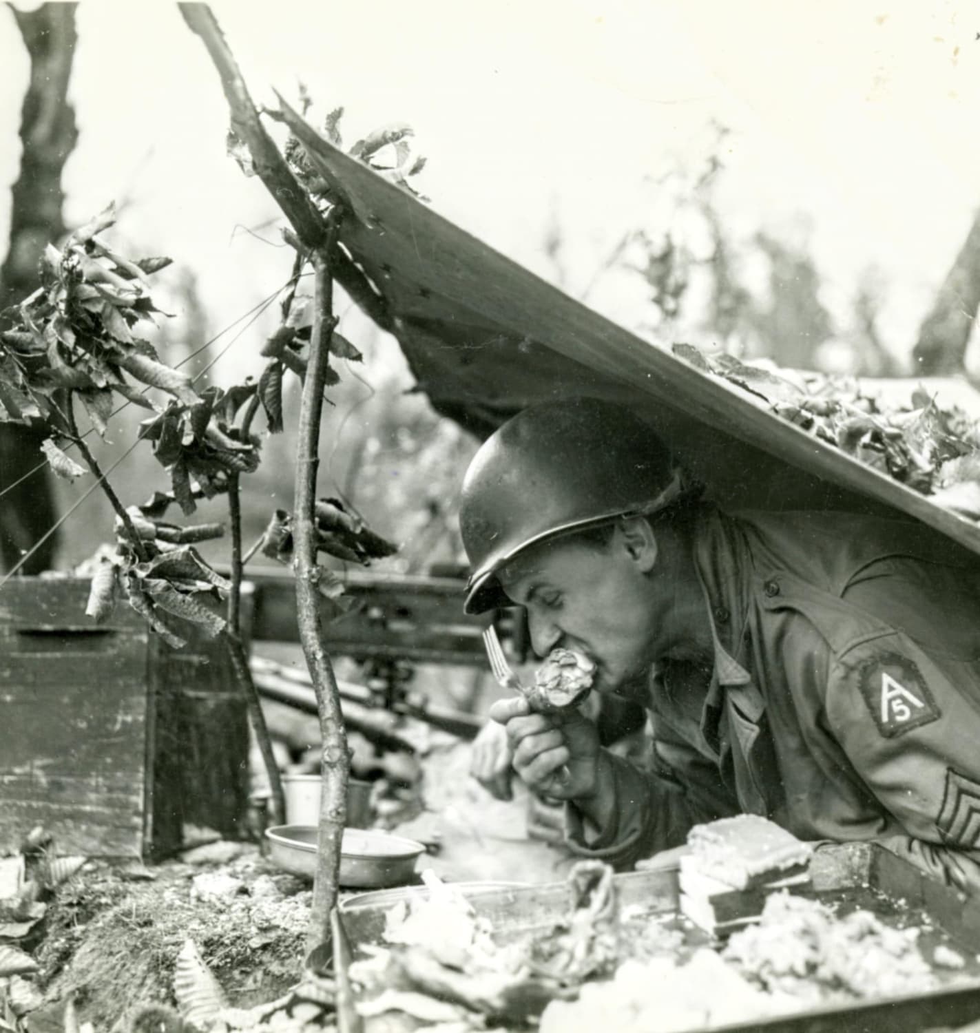 Thanksgiving chow— Sgt. Frank Shiborski, 107 AAA Group, 5th Army, from Detroit, Michigan, takes time out from looking for Germans to do a little special duty on a 'drum stick.' San Marcello Pistoiese Area, Italy. November22, 1944.