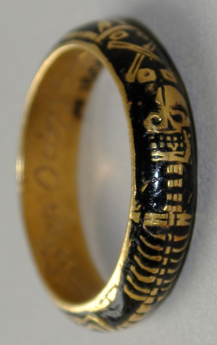 A skeleton wraps around the hoop of this gold mourning ring, enamelled in black. The skeleton is joined by symbols of death - spade & pick, crossed bones and hourglass. Inscribed for Cpt Robert Jackson - died 29 Oct 1726 (@britishmuseum)
