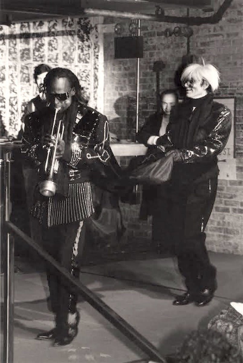 Miles Davis and Andy Warhol model in a fashion show by Japanese designer Kohshin Satoh at Tunnel nightclub in New York, 1987