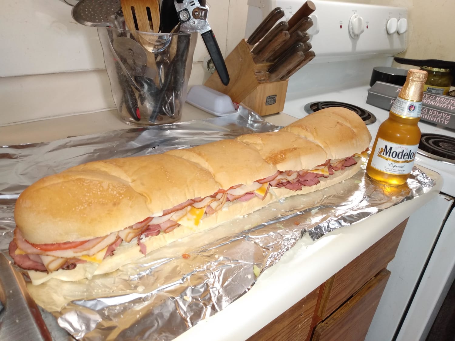 [Homemade] Comically large 4 meat, 3 cheese submarine sandwich. Modelo for scale.
