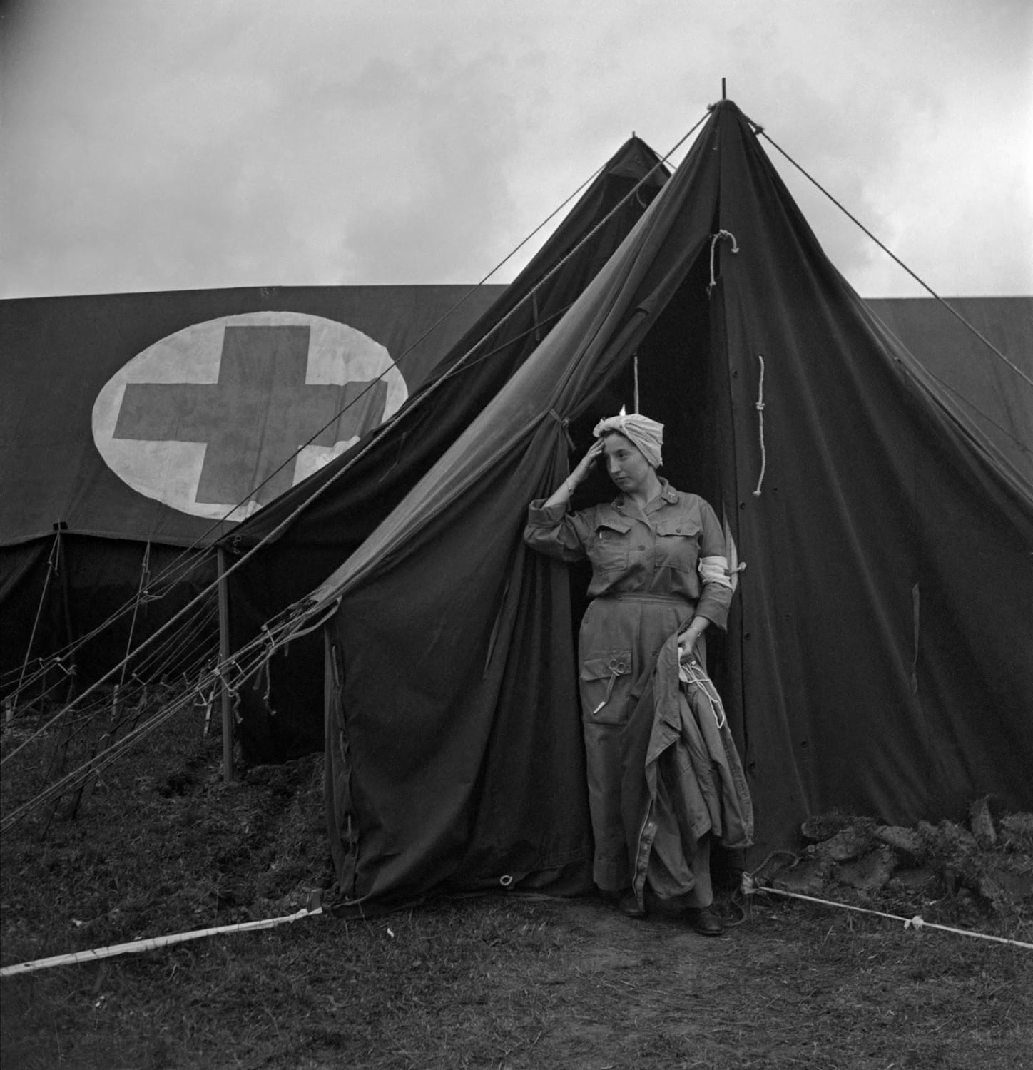 An exhausted nurse at the 44th evacuation hospital, Normandy, France, 1944.