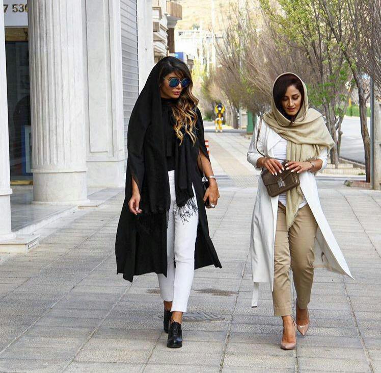 Two Iranian women walking down the street