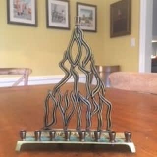 "This is our family menorah. We lit it every Hanukkah when I was a child, when I returned home as a young adult and later for my children when we celebrated the holiday at my parents’ house. My mother, was a 1st generation American... As a kid, she often…