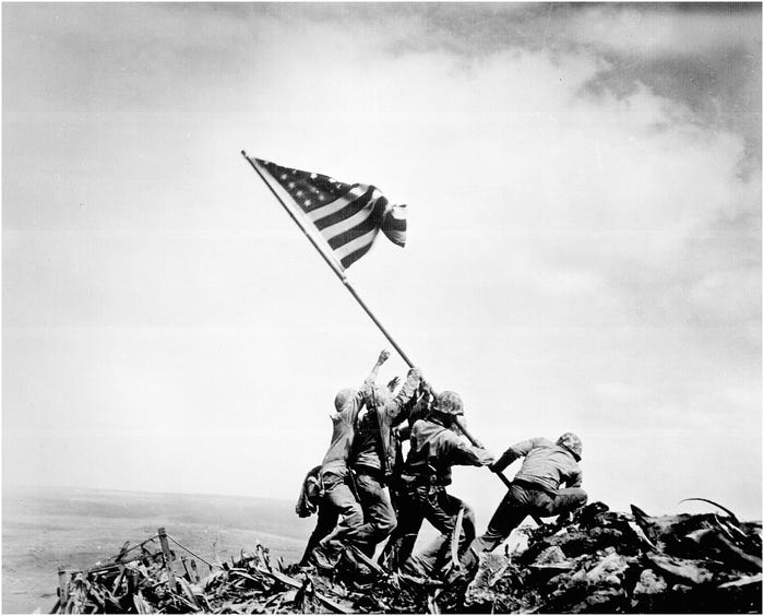 Five Marines and a Navy corpsman plant a US flag after the bloody battle for Iwo Jima in 1945 .
