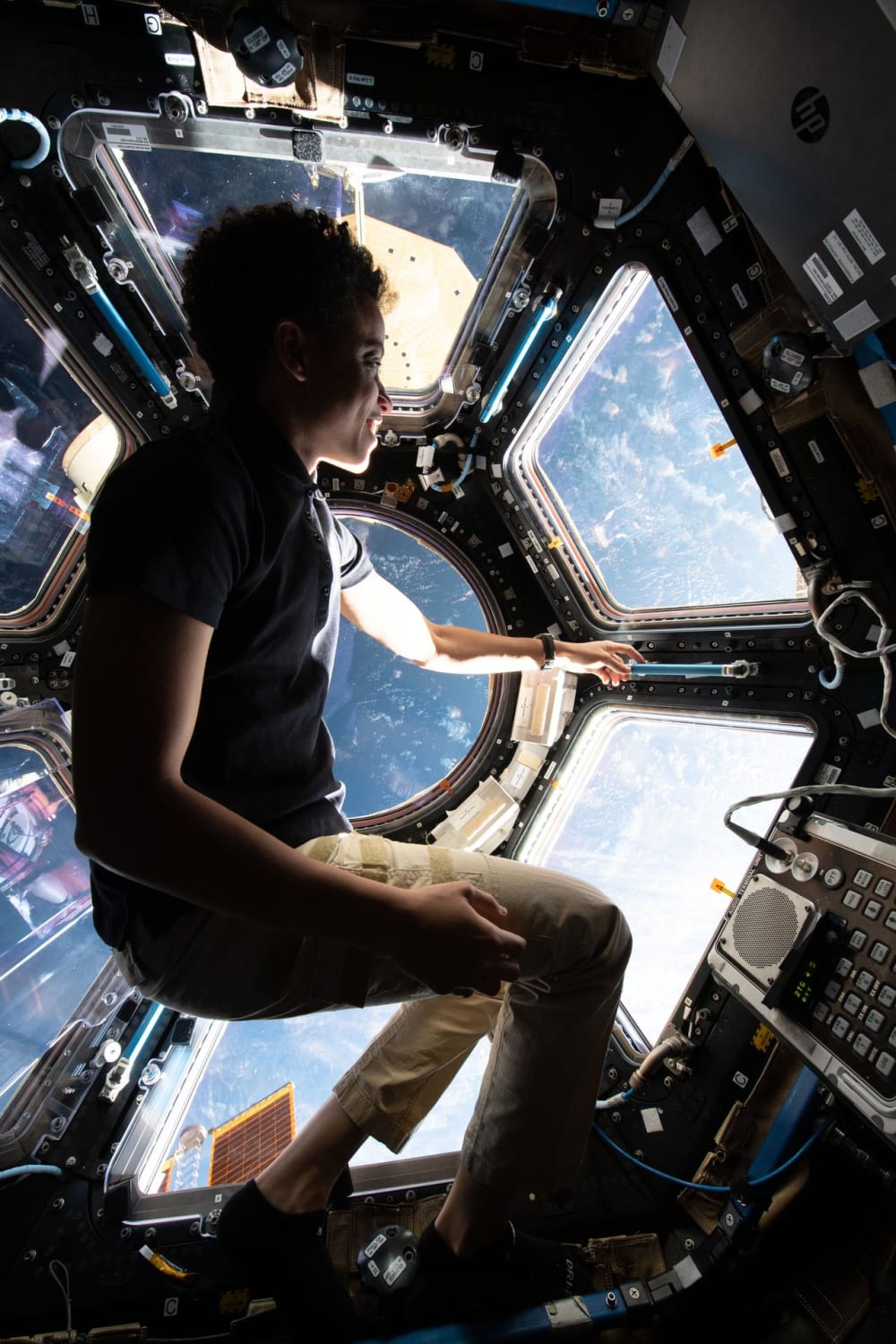 NASA astronaut and Expedition 67 Flight Engineer Jessica Watkins enjoys the view of the Earth below from inside the International Space Station's seven-windowed cupola.