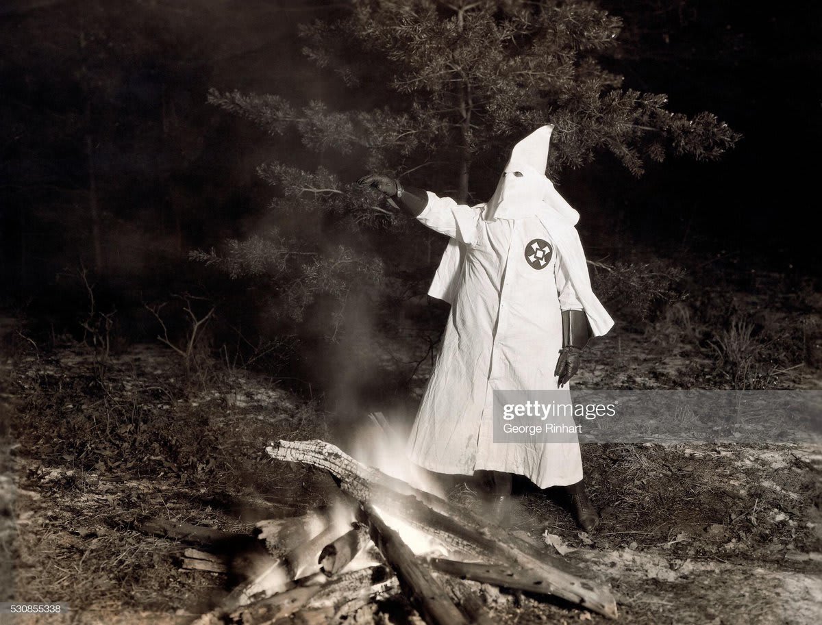 In the western Maryland wilderness, the Grand Goblin of the Ku Klux Klan presides over an initiation of 250 new members, which took three hours despite the extreme cold.
