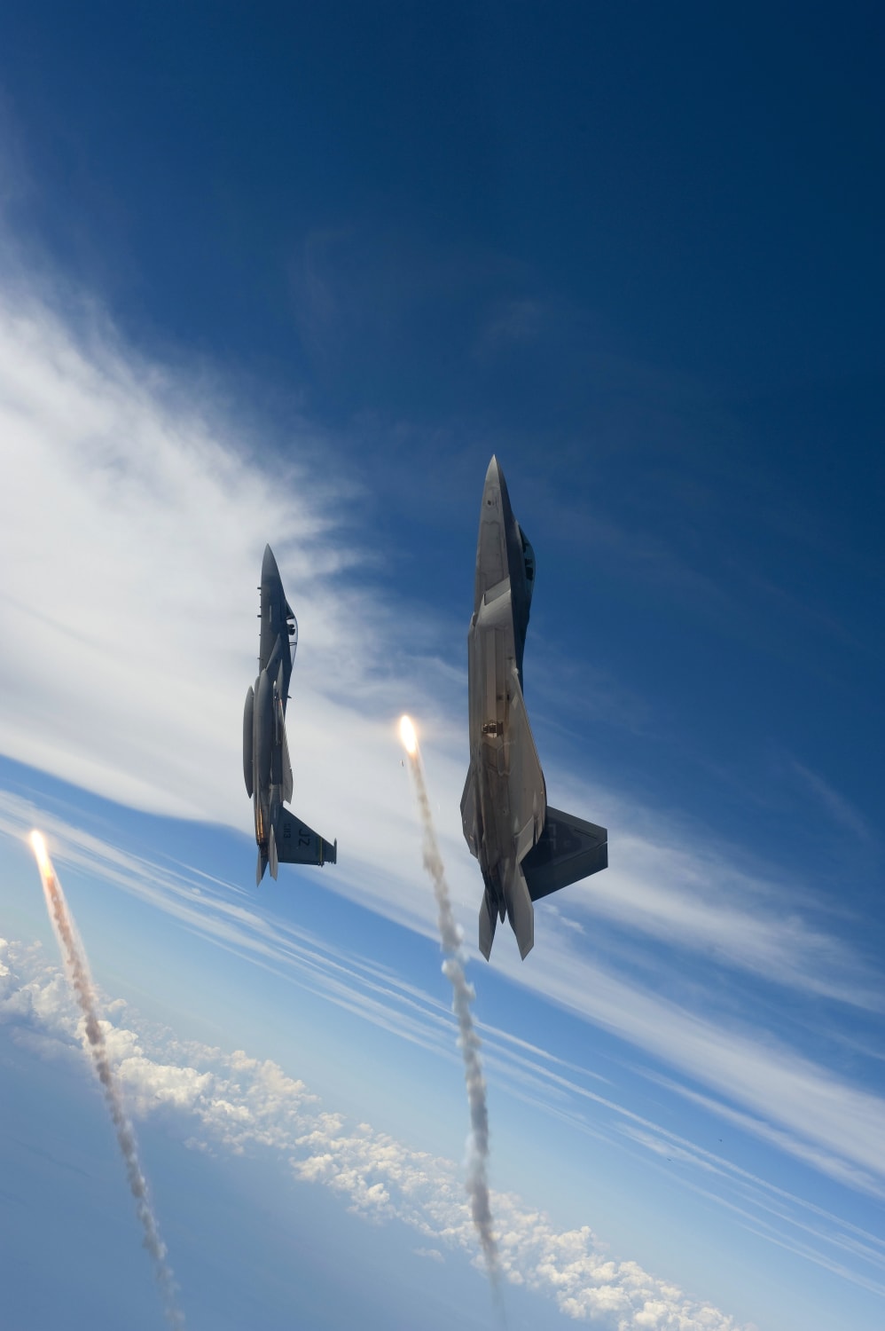 An F-15 & an F-22 each pop off a flare over the Gulf of Mexico -- Photo by USAF Staff Sgt. James L. Harper Jr.